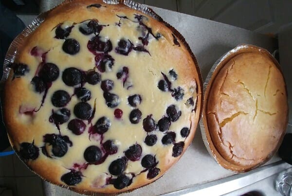 Blueberry raspberry raspberry cheesecake and aregular cheesecake on a counter